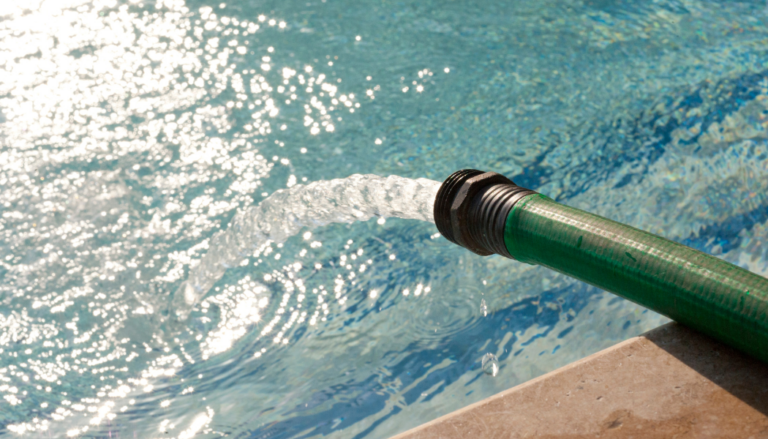 The image shows a hose with running water into a pool.